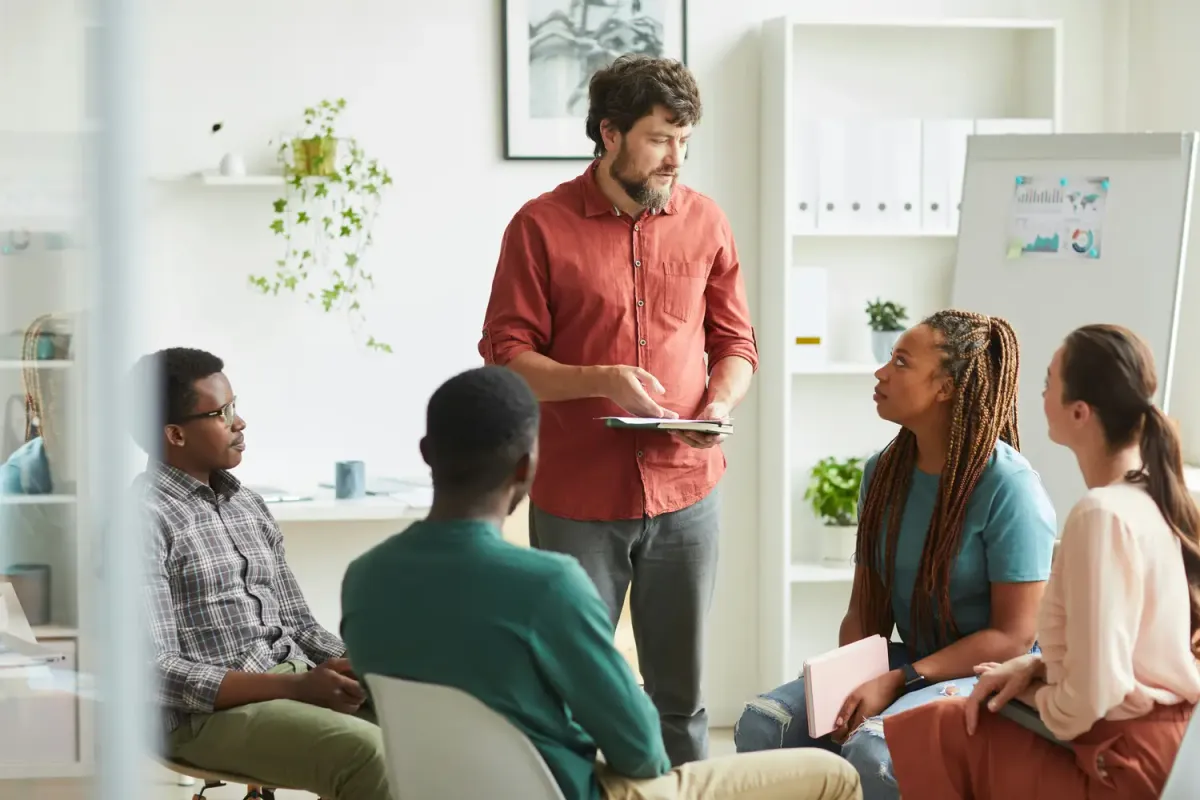 Colleagues reviewing work together around a conference table
