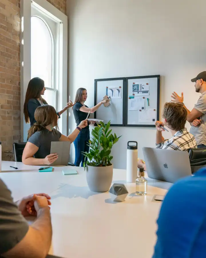 Marketing team presenting work on boards during a planning session